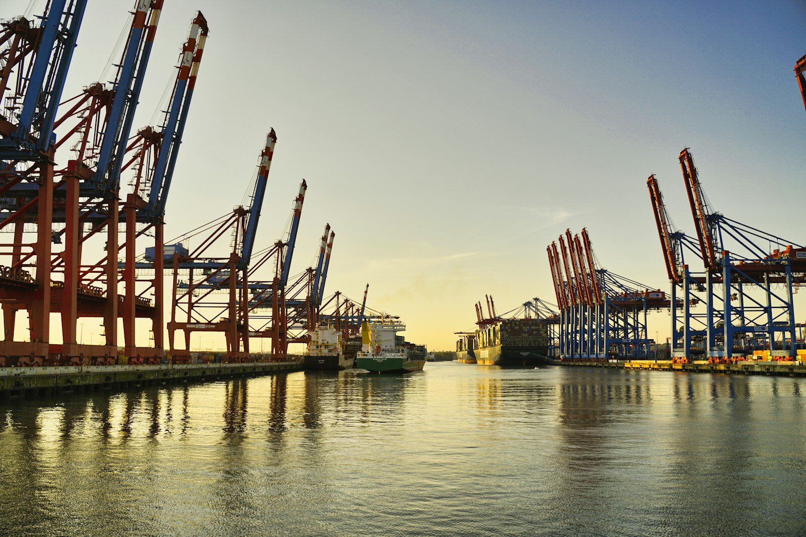 Container ships being loaded by cranes at port